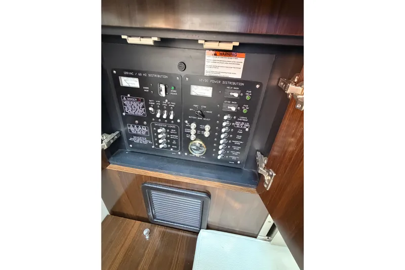 Slide: The Image of Electrical panel inside 2021 Cruisers Yachts 338 Bow Rider, showcasing power distribution controls. - 30