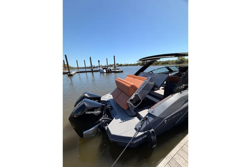 Slide: The Image of 2021 Cruisers Yachts 338 Bow Rider docked, featuring Mercury outboard engines. - 5