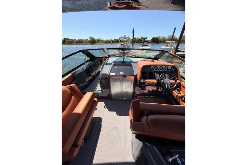 Slide: The Image of 2021 Cruisers Yachts 338 Bow Rider interior with luxurious seating and modern dashboard. - 8