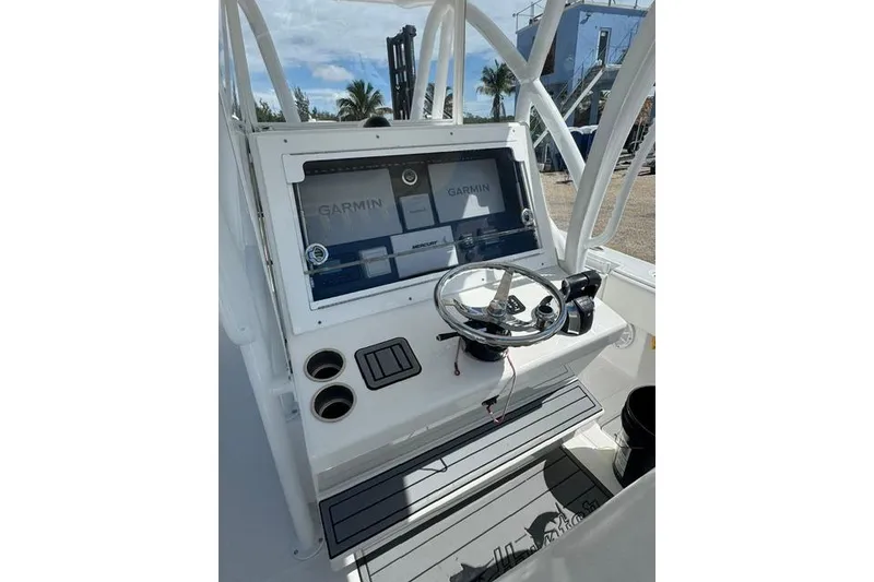Slide: The Image of 2022 SeaHunter 28 Floridian boat console with Garmin navigation system and steering wheel. - 12
