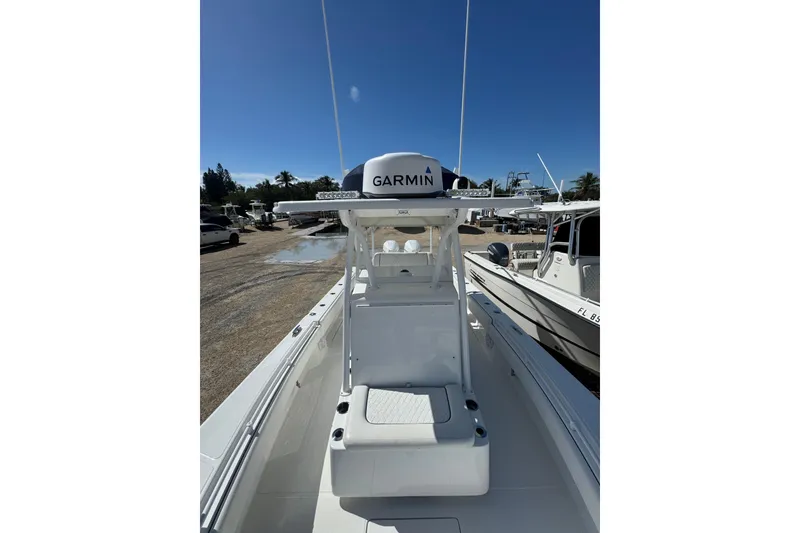 Slide: The Image of 2022 SeaHunter 28 Floridian boat with Garmin equipment, docked under clear blue sky. - 2