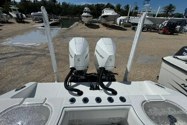 Slide: The Image of 2022 SeaHunter 28 Floridian boat with dual Mercury engines at a marina. - 4