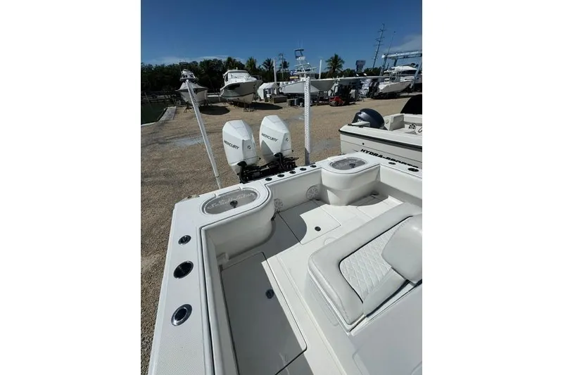 Slide: The Image of 2022 SeaHunter 28 Floridian boat with dual Mercury engines docked outdoors. - 5
