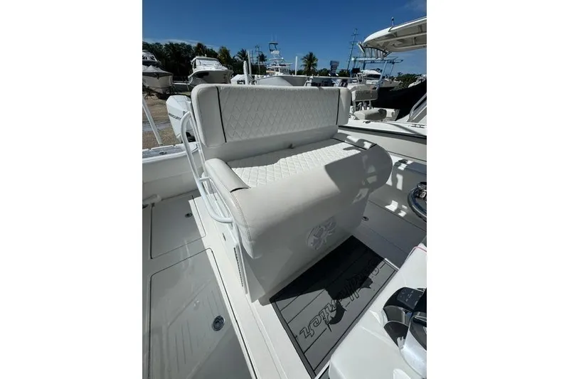 Slide: The Image of 2022 SeaHunter 28 Floridian boat interior with cushioned seating and deck view. - 6