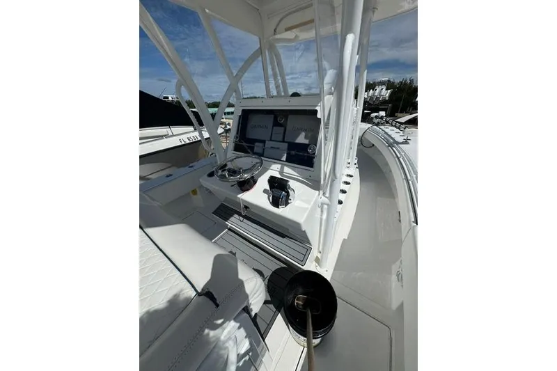 Slide: The Image of 2022 SeaHunter 28 Floridian boat cockpit with modern navigation equipment and steering wheel. - 7