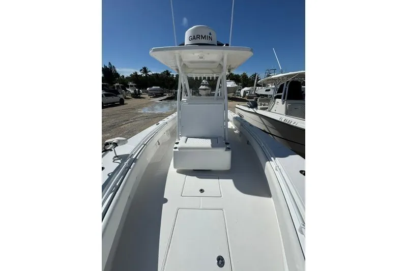 Slide: The Image of 2022 SeaHunter 28 Floridian boat with Garmin equipment, docked under clear blue sky. - 8