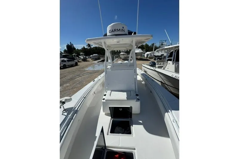 Slide: The Image of 2022 SeaHunter 28 Floridian boat with Garmin equipment, docked under clear blue sky. - 9