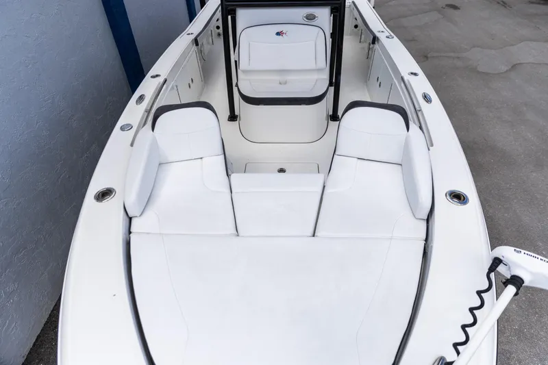 Slide: The Image of 2023 Crevalle 26 HCO boat interior with white seating and modern design. - 12