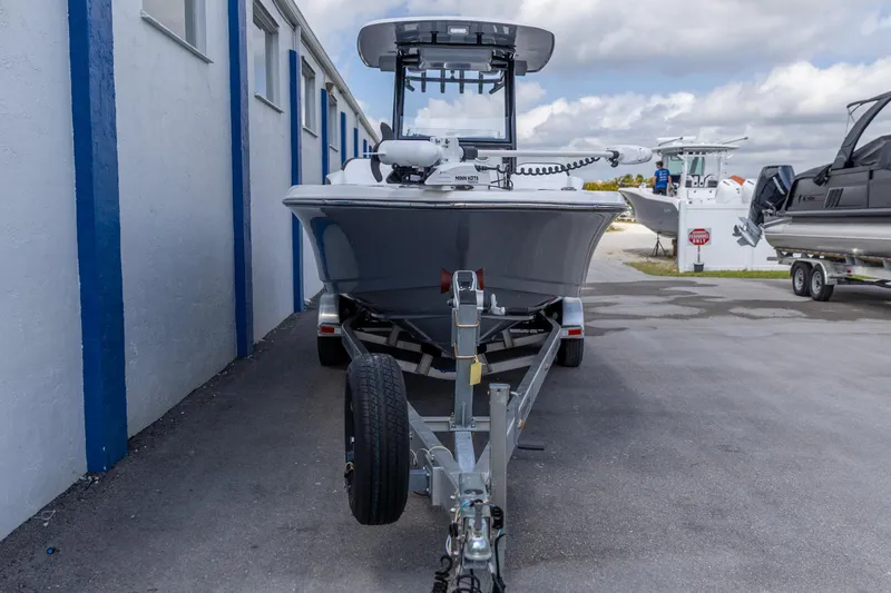 Slide: The Image of 2023 Crevalle 26 HCO boat on trailer, parked outdoors near a building. - 13