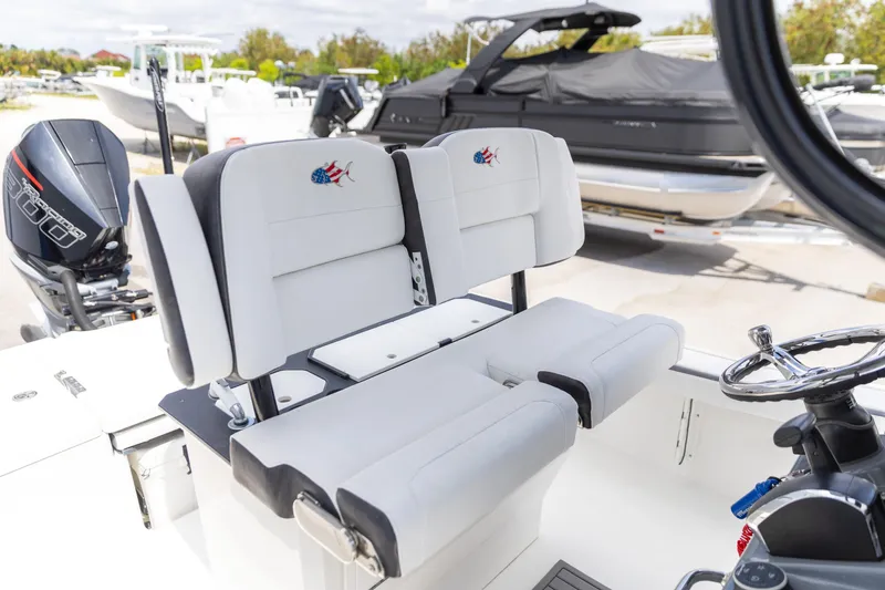 Slide: The Image of 2023 Crevalle 26 HCO boat interior with dual seating and steering wheel. - 4