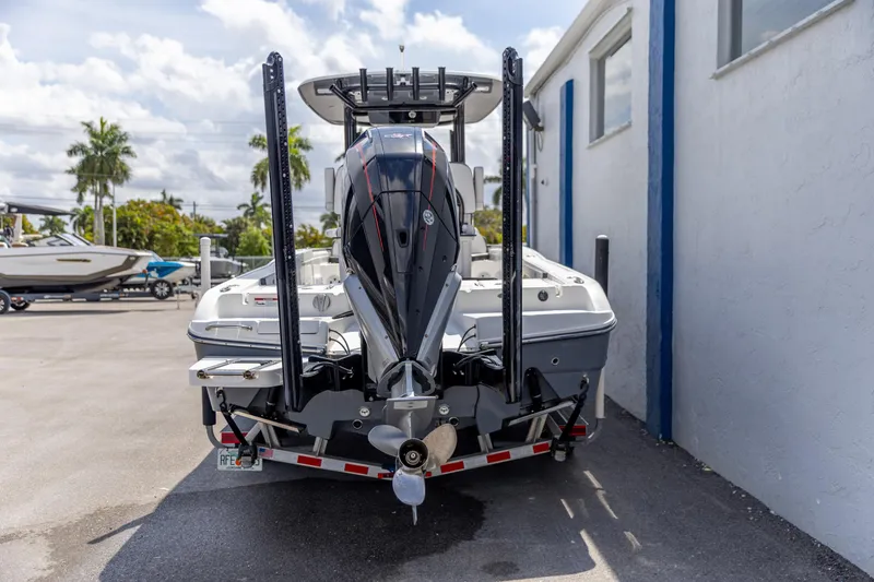Slide: The Image of 2023 Crevalle 26 HCO boat with powerful outboard motor, parked outdoors. - 6