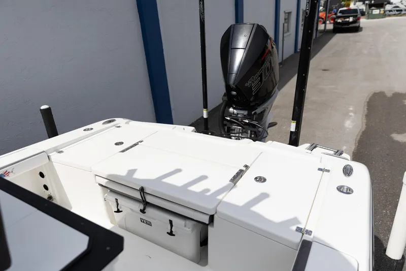 Slide: The Image of 2023 Crevalle 26 HCO boat with outboard motor and Yeti cooler on deck. - 9