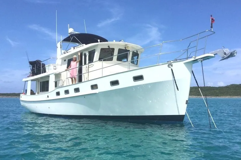 The Image of Kadey-Krogen 48 AE yacht from 2011 on clear blue water, with a person on deck. - 1