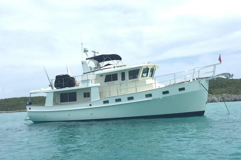 Slide: The Image of 2011 Kadey-Krogen 48 AE yacht anchored in clear blue water. - 10