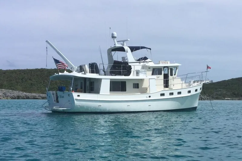 Slide: The Image of Kadey-Krogen 48 AE 2011 yacht anchored in clear blue water, scenic background. - 12