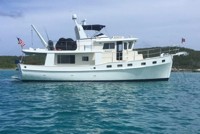 Slide: The Image of 2011 Kadey-Krogen 48 AE yacht anchored in clear blue water. - 14