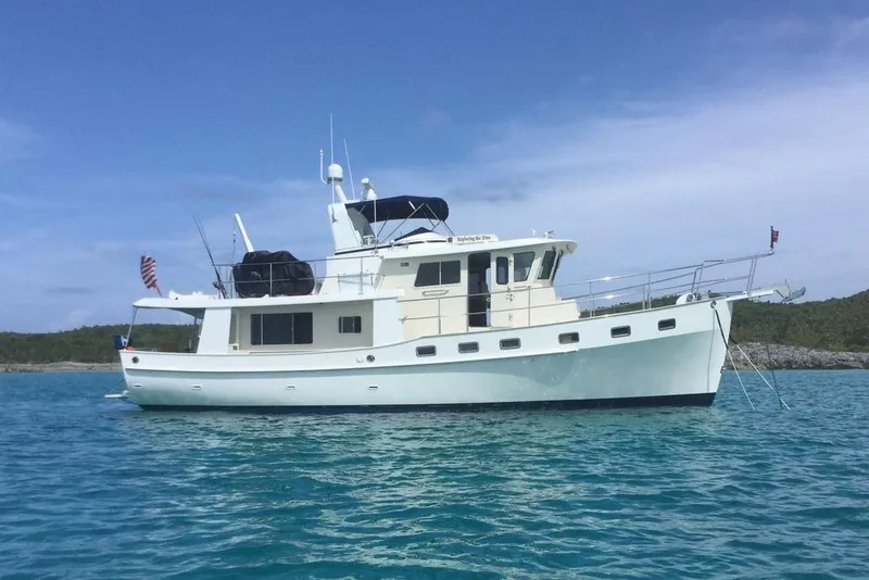Slide: The Image of 2011 Kadey-Krogen 48 AE yacht anchored in clear blue water. - 15