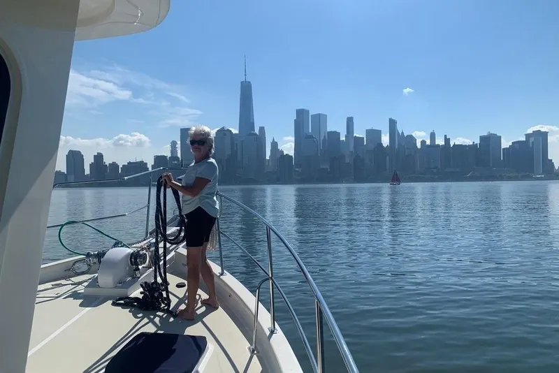 Slide: The Image of Woman on 2011 Kadey-Krogen 48 AE yacht with city skyline in background. - 18