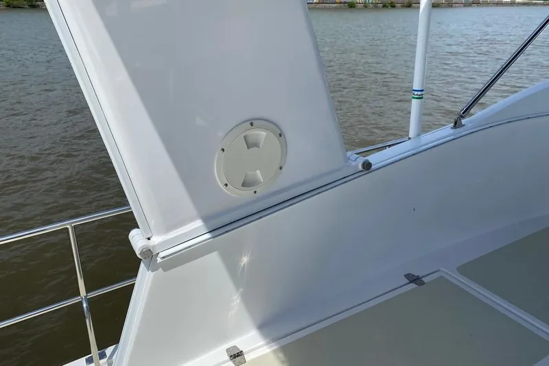 Slide: The Image of 2011 Kadey-Krogen 48 AE yacht deck detail with railing and water view. - 21