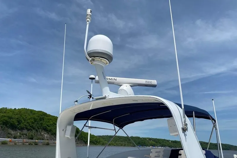 Slide: The Image of Kadey-Krogen 48 AE 2011 yacht with Garmin radar, blue canopy, and antennas. - 23