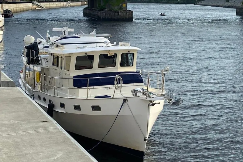 Slide: The Image of Kadey-Krogen 48 AE 2011 yacht docked on a calm river. - 28