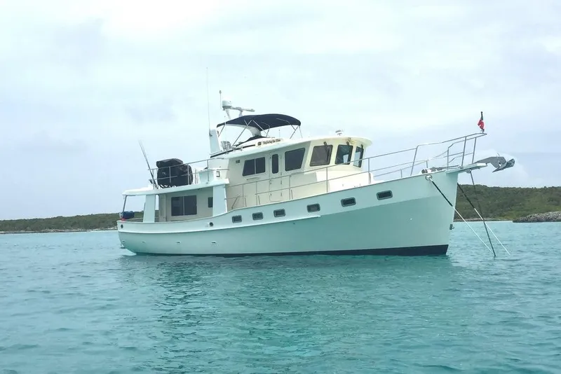 Slide: The Image of 2011 Kadey-Krogen 48 AE yacht anchored in clear blue water. - 3