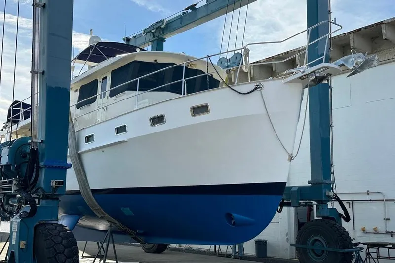 Slide: The Image of Kadey-Krogen 48 AE 2011 yacht in dry dock, blue and white hull, under maintenance. - 38