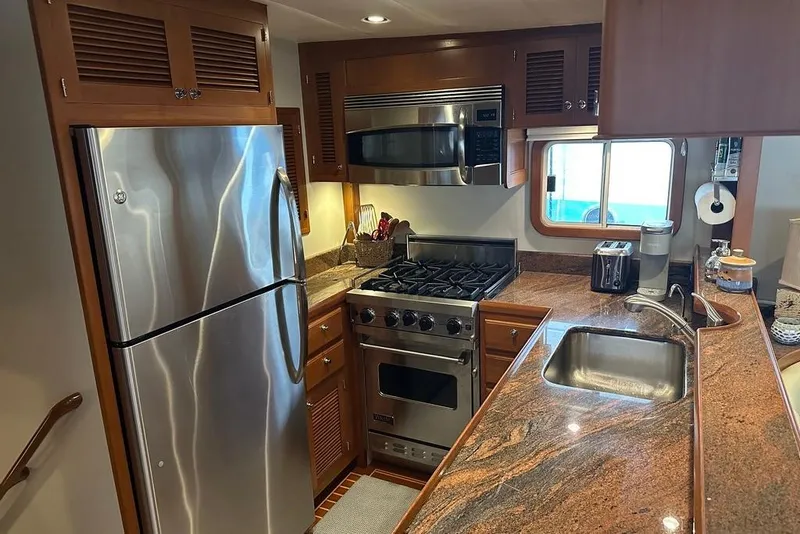 Slide: The Image of Luxurious 2011 Kadey-Krogen 48 AE yacht kitchen with stainless steel appliances and granite countertops. - 46