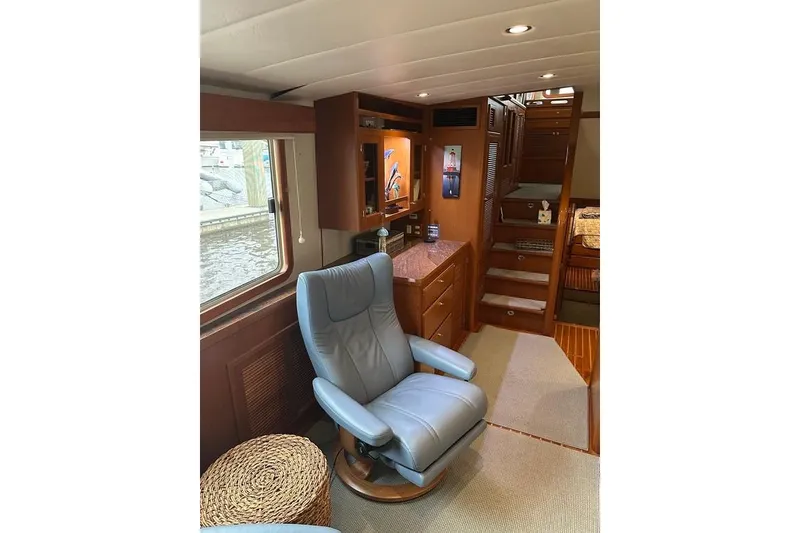 Slide: The Image of Luxurious interior of 2011 Kadey-Krogen 48 AE yacht with leather chair and wooden cabinetry. - 49