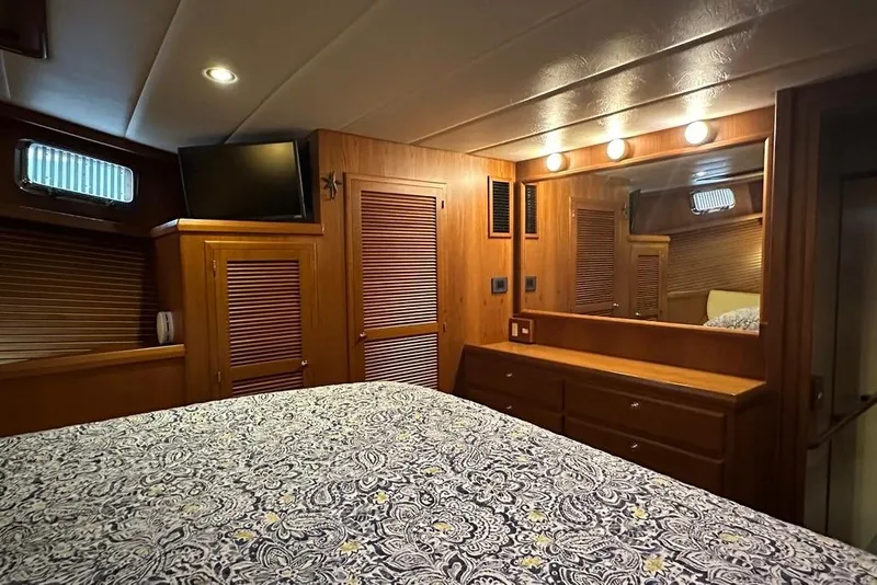 Slide: The Image of Luxurious 2011 Kadey-Krogen 48 AE yacht bedroom with wood paneling and elegant decor. - 51