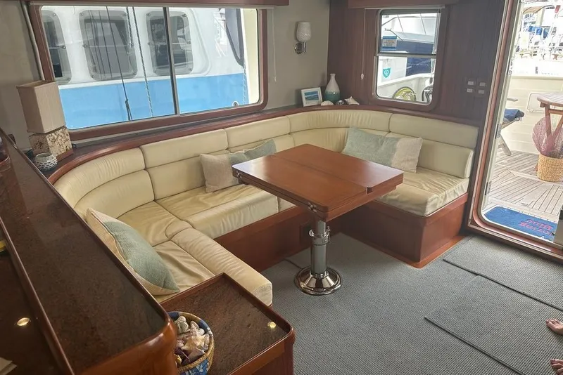 Slide: The Image of Luxurious 2011 Kadey-Krogen 48 AE yacht interior with plush seating and wooden table. - 53