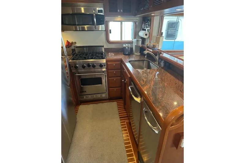 Slide: The Image of Luxurious 2011 Kadey-Krogen 48 AE yacht kitchen with stainless steel appliances and granite countertops. - 56