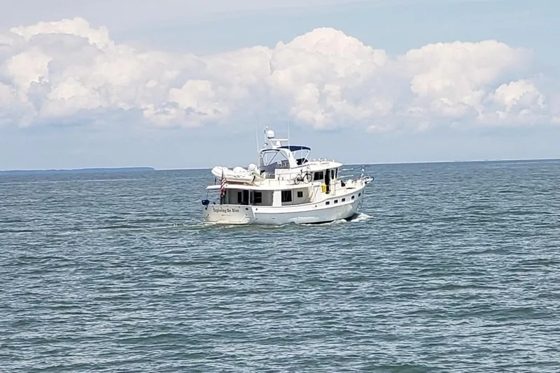 Slide: The Image of 2011 Kadey-Krogen 48 AE yacht cruising on open sea under cloudy sky. - 6