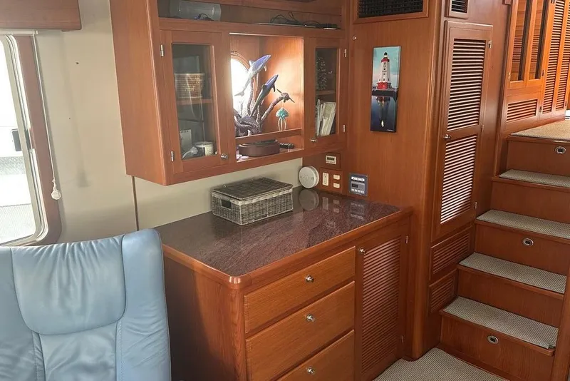 Slide: The Image of Luxurious 2011 Kadey-Krogen 48 AE yacht interior with wooden cabinetry and staircase. - 60