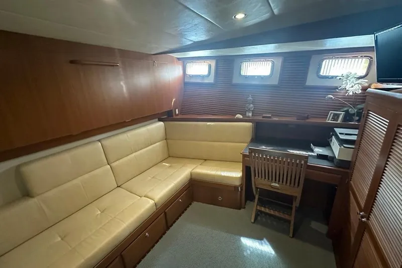 Slide: The Image of Luxurious interior of 2011 Kadey-Krogen 48 AE yacht with beige seating and wooden desk. - 61