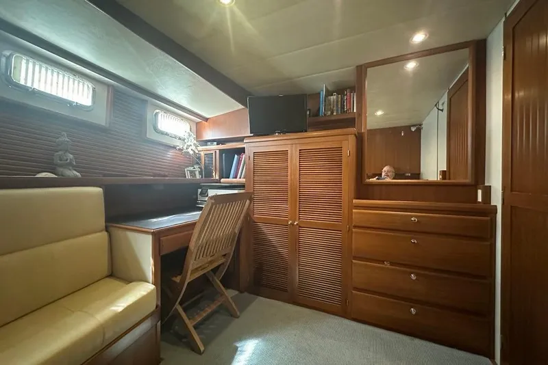Slide: The Image of Luxurious 2011 Kadey-Krogen 48 AE yacht interior with wooden cabinetry and cozy seating area. - 62