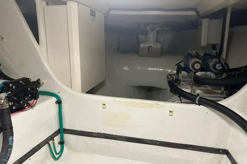 Slide: The Image of Engine room of 2011 Kadey-Krogen 48 AE yacht, showcasing mechanical components and wiring. - 64