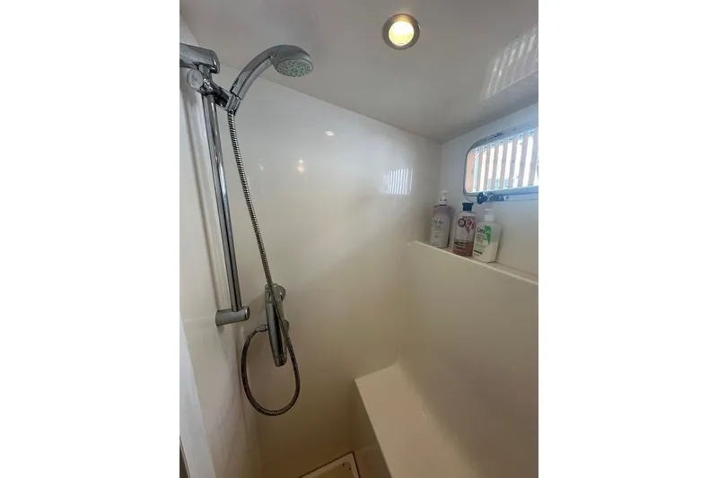 Slide: The Image of Shower area in 2011 Kadey-Krogen 48 AE yacht with handheld showerhead and toiletries. - 67