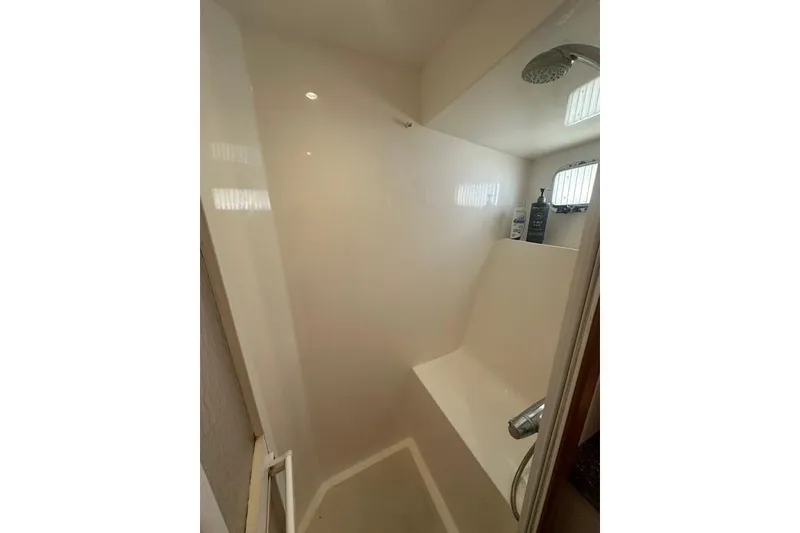 Slide: The Image of Shower area in 2011 Kadey-Krogen 48 AE yacht, featuring a sleek design and built-in seat. - 70