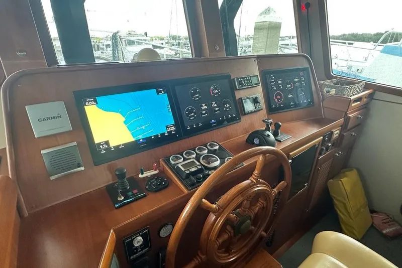 Slide: The Image of Kadey-Krogen 48 AE 2011 yacht helm with Garmin navigation displays and wooden steering wheel. - 72