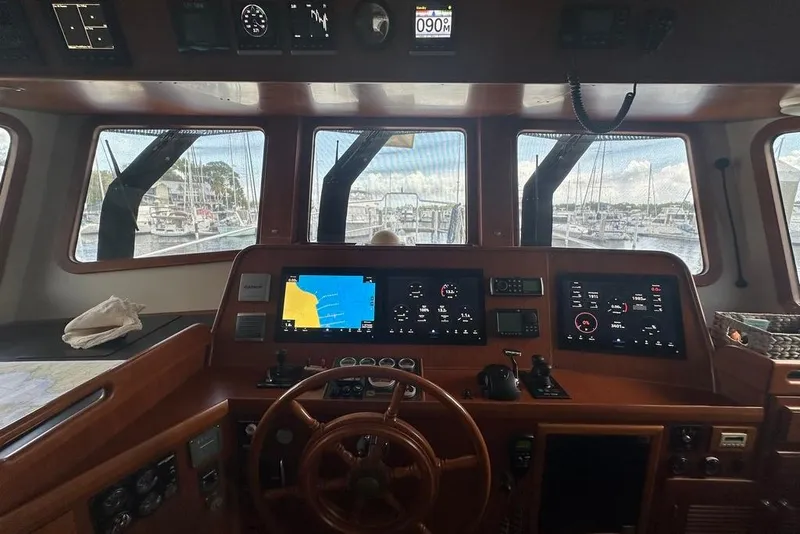 Slide: The Image of Pilothouse of 2011 Kadey-Krogen 48 AE yacht with navigation screens and wooden steering wheel. - 73