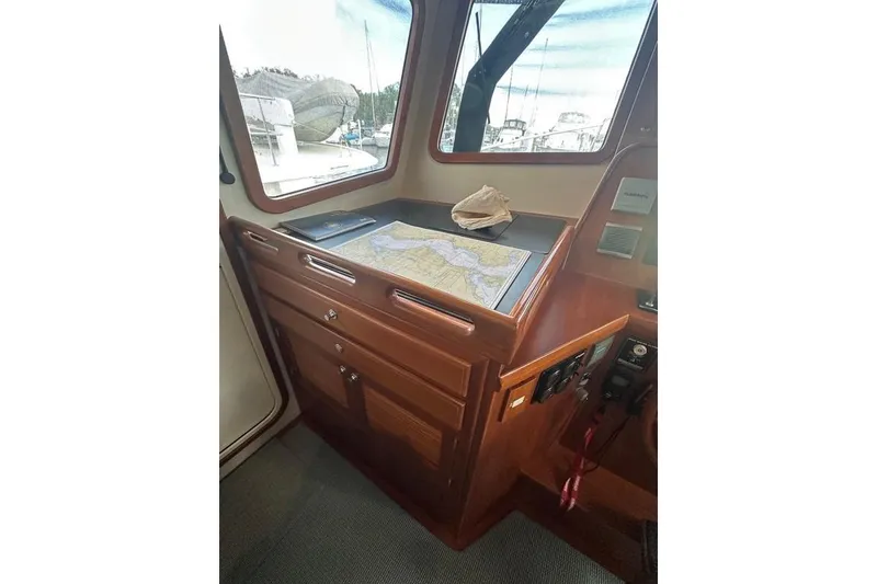 Slide: The Image of Kadey-Krogen 48 AE 2011 yacht interior with navigation map and wooden cabinetry. - 77