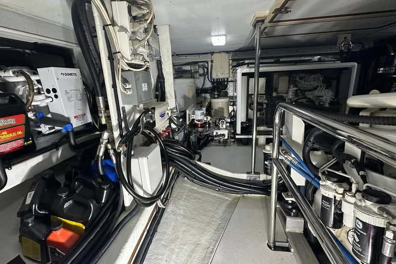 Slide: The Image of Engine room of a 2011 Kadey-Krogen 48 AE yacht, showcasing equipment and wiring. - 80