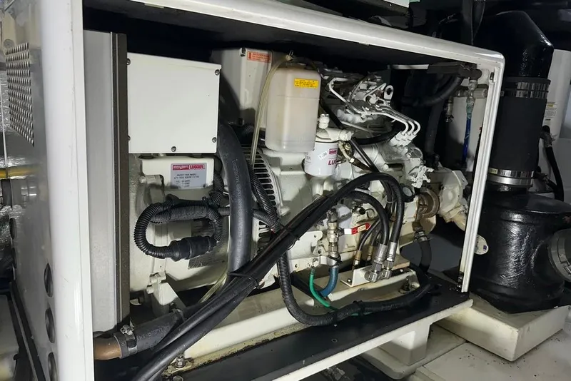 Slide: The Image of Engine compartment of a 2011 Kadey-Krogen 48 AE yacht, showcasing mechanical components. - 81