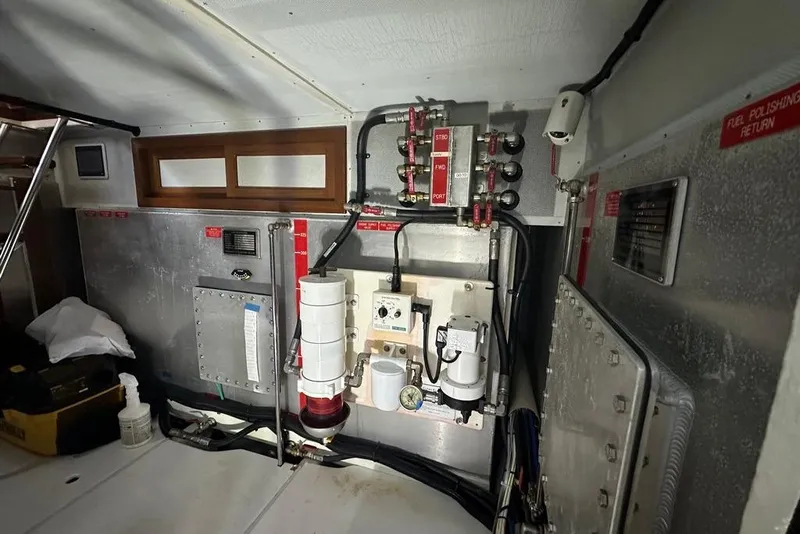 Slide: The Image of Engine room of 2011 Kadey-Krogen 48 AE yacht, featuring fuel system components and control panels. - 83