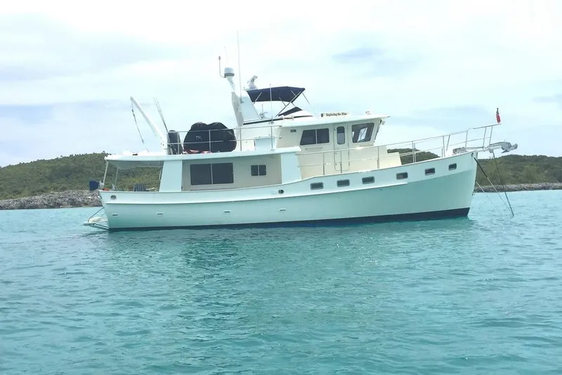 Slide: The Image of 2011 Kadey-Krogen 48 AE yacht anchored in clear blue water. - 9
