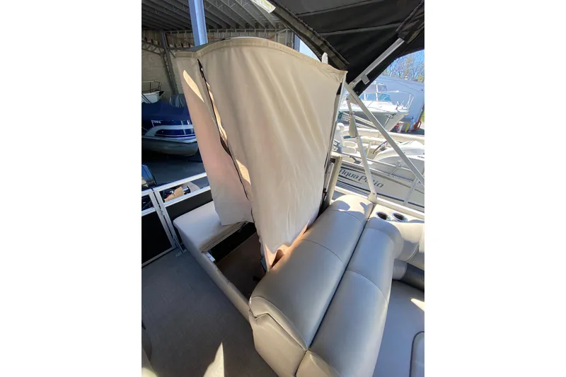 Slide: The Image of 2021 Sun Tracker Party Barge 22 DLX interior with seating and privacy curtain. - 10