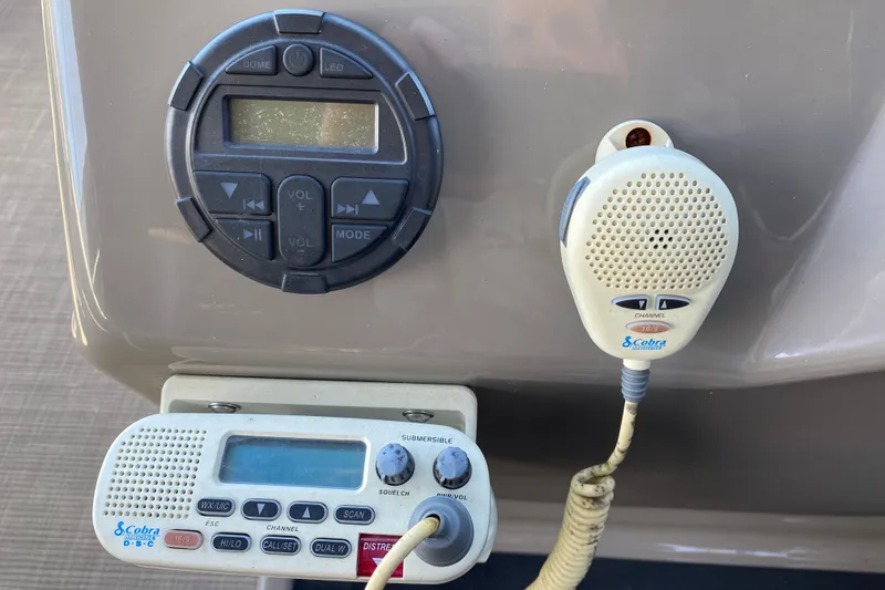 Slide: The Image of Sun Tracker Party Barge 22 DLX 2021 dashboard with radio and communication controls. - 14