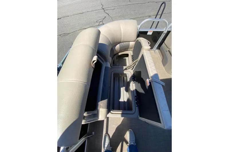Slide: The Image of 2021 Sun Tracker Party Barge 22 DLX interior with open storage compartments. - 15