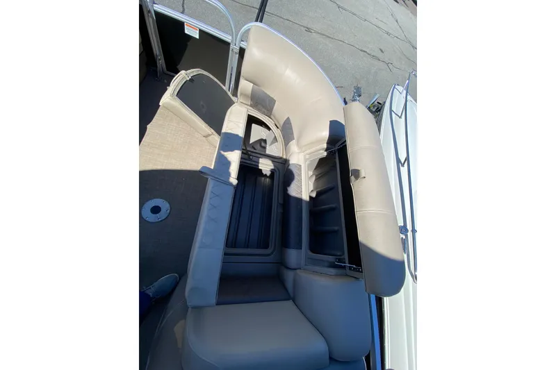 Slide: The Image of 2021 Sun Tracker Party Barge 22 DLX interior seating with storage compartment open. - 19